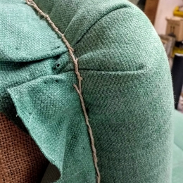 Hand sewn fabric pleats on sofa