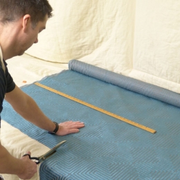 Sean Price cutting fabric